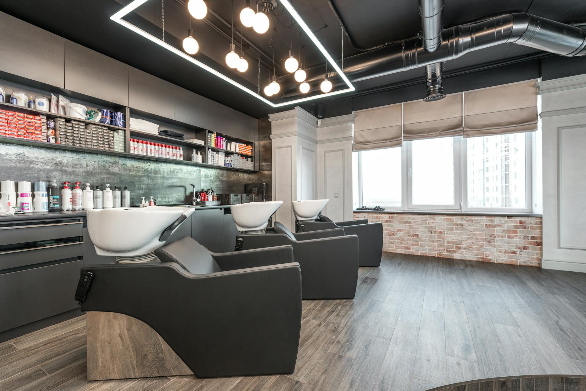 Backwash chairs in stylish beauty salon with cosmetology supplies