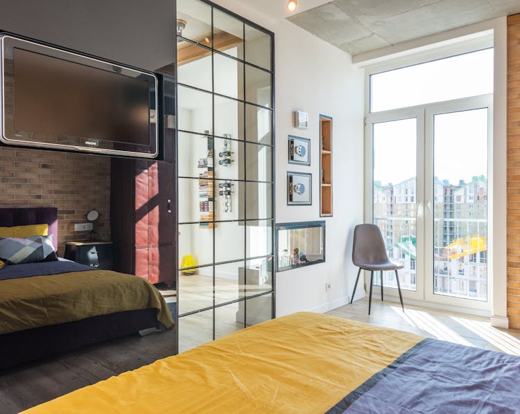 Decorated Bedroom With Mirror And Bed