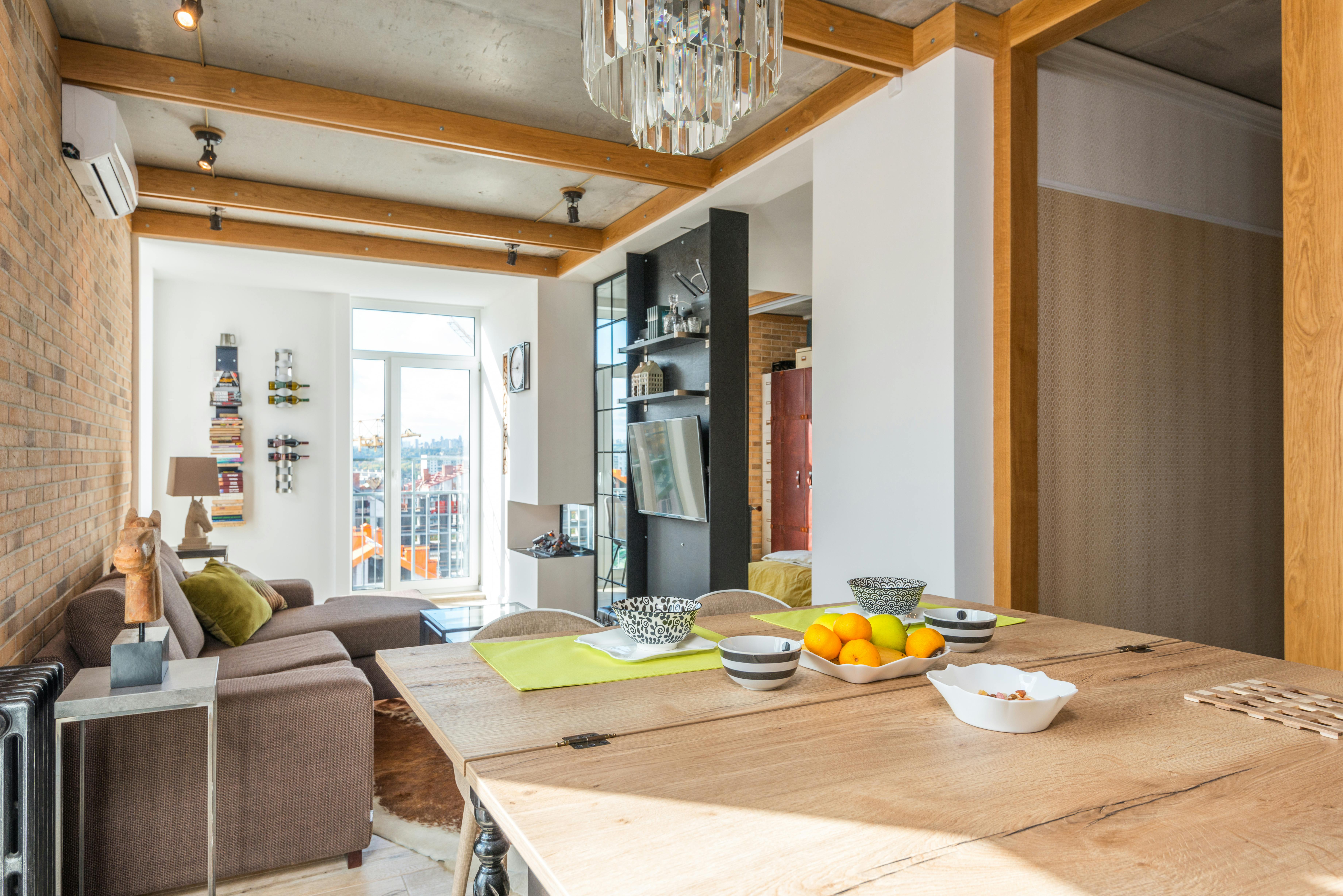 wooden table with dishware near couch