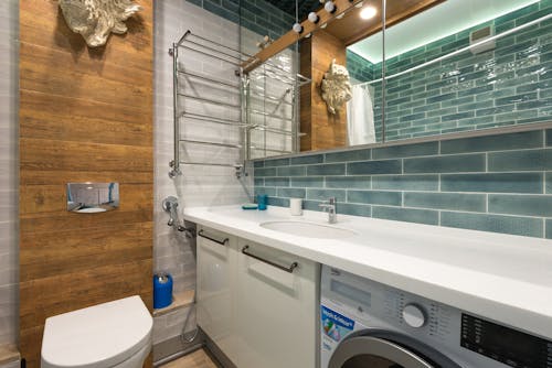 Green Wall Tiles with White Counter Top Bathroom