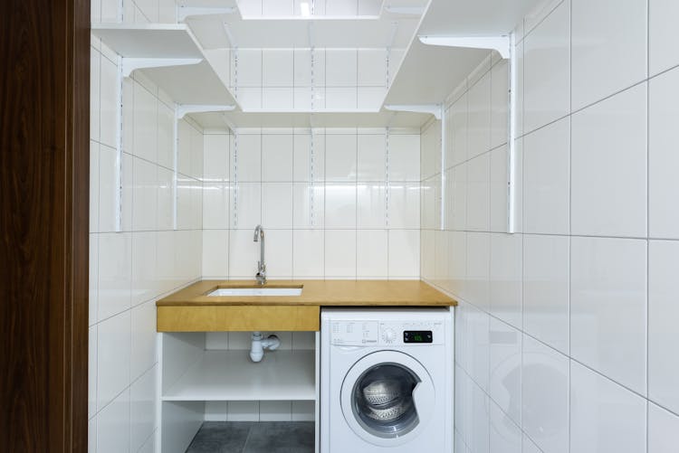 Laundry Area With White Tiled Walls