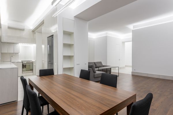 Walnut dining table in a bright minimal interior — photo by Max Vakhtbovych on Pexels