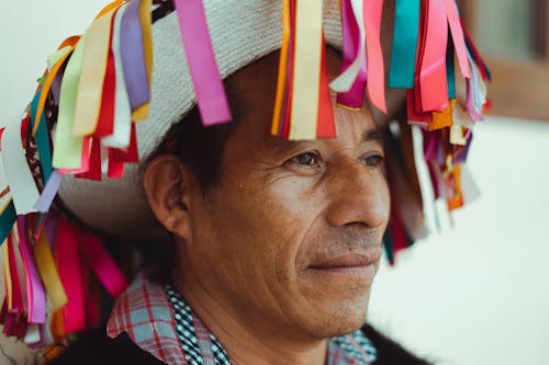 Close-Up Photo Of Man Wearing Traditional Hat