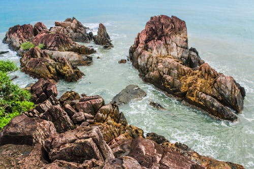 Brown Rock Formations Beside Ocean