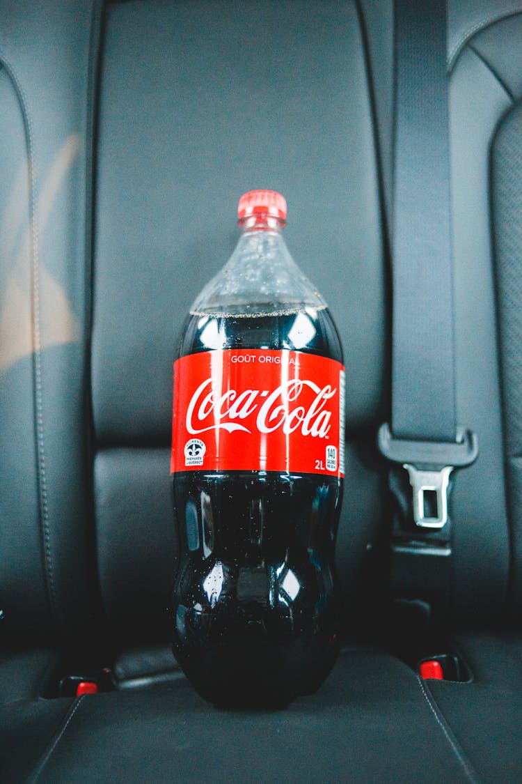 Cola In Plastic Bottle On Car Seat