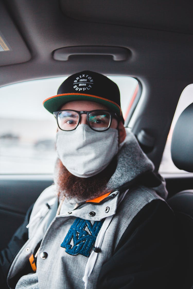 Man With Beard Wearing Protective Mask In Car