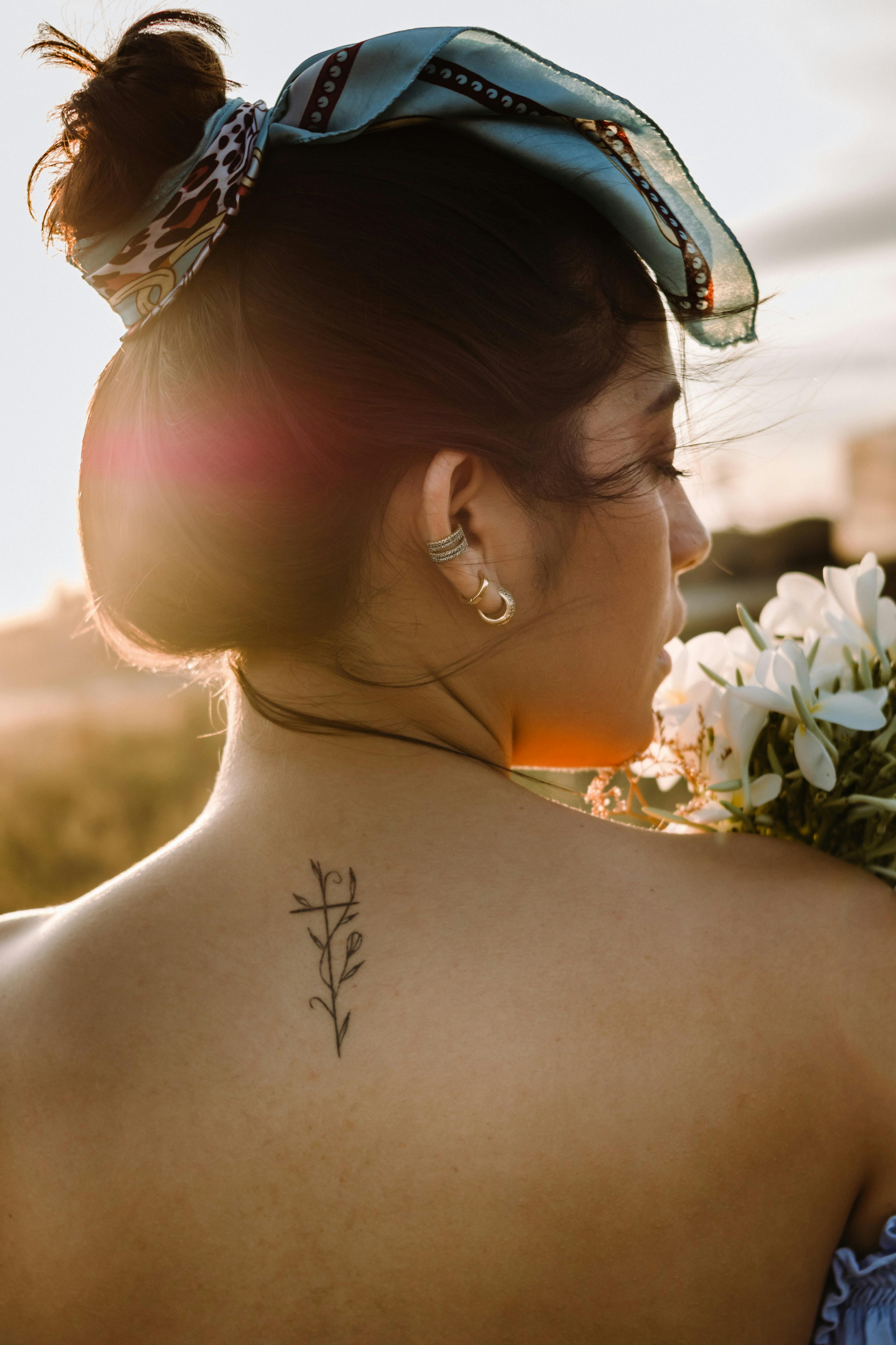 beautiful young lady with back tattoo. Stock Photo | Adobe Stock