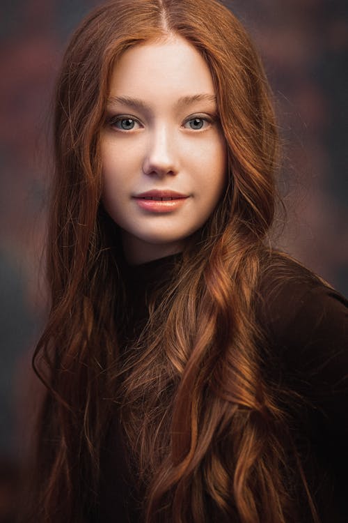 Free Calm woman with long wavy red hair Stock Photo