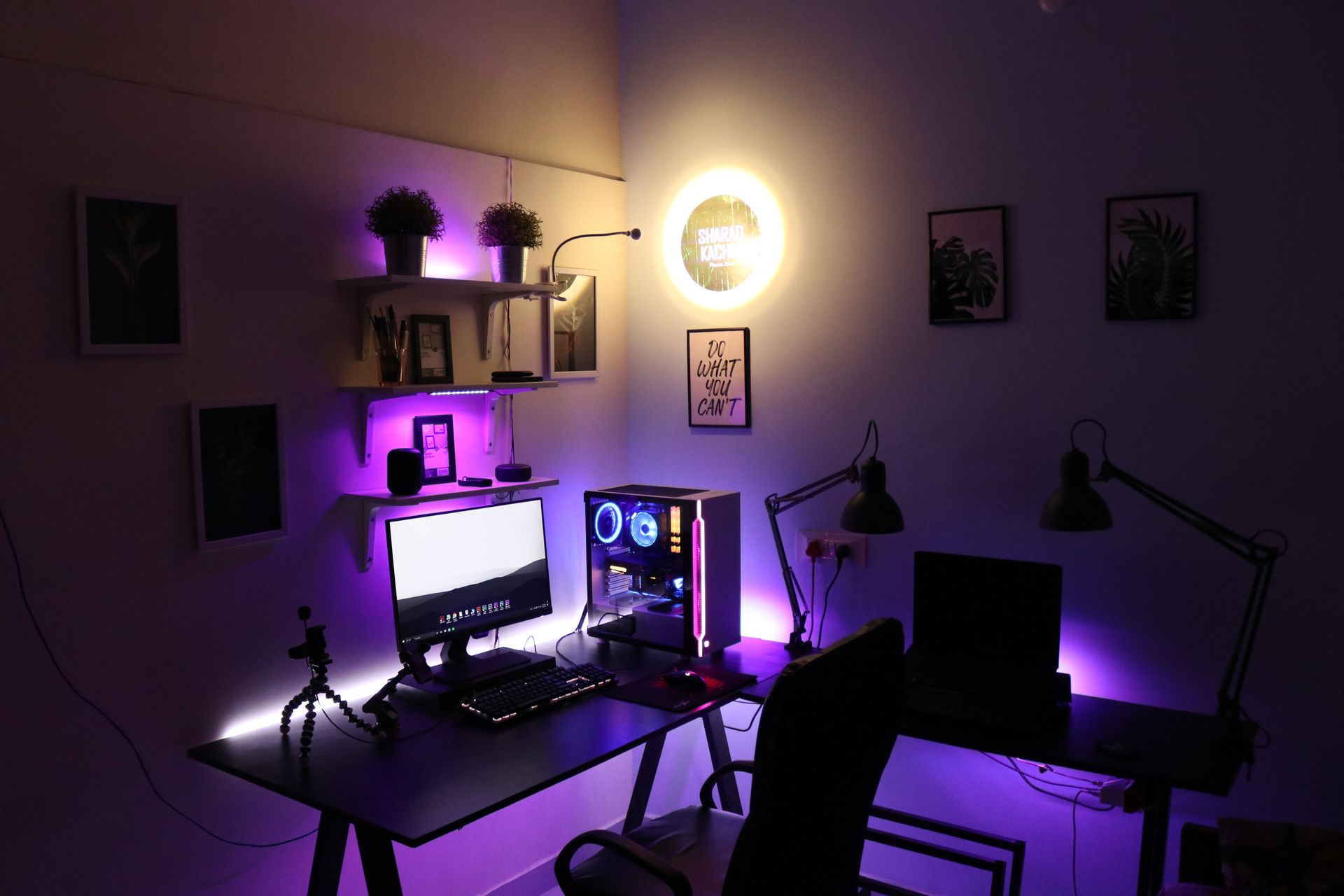 Contemporary office setup with dual monitors and purple LED lighting, perfect for tech enthusiasts.