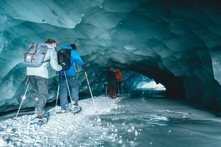 Hikers Walking On A Frozen Cave