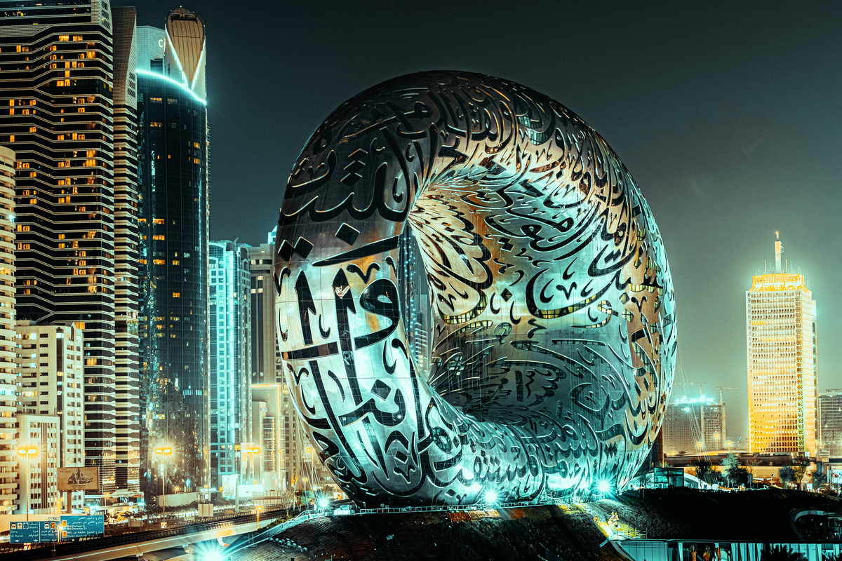 The torus-shaped Museum of the Future with Arabic calligraphy, illuminated at night