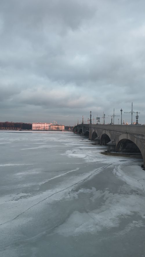 Free Aged Trinity Bridge crossing frozen Neva river placed in Saint Petersburg in Russia under cloudy sky in daytime Stock Photo