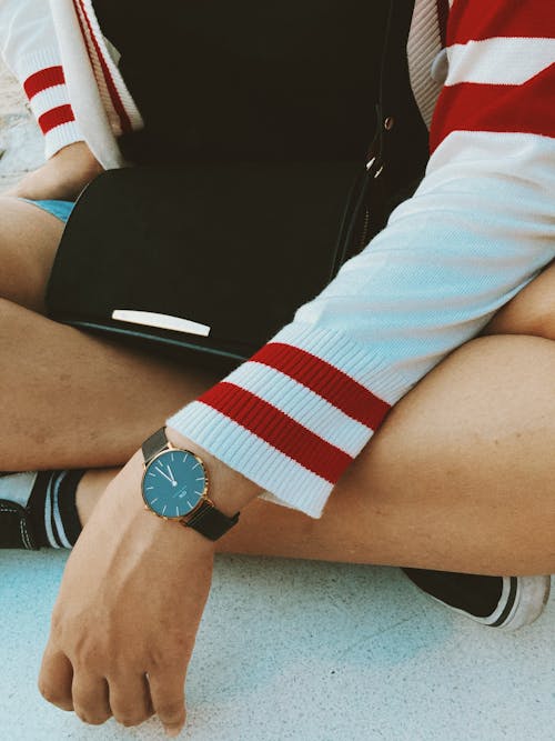 Person Wearing Red and White Striped Jacket Sitting on the Floor