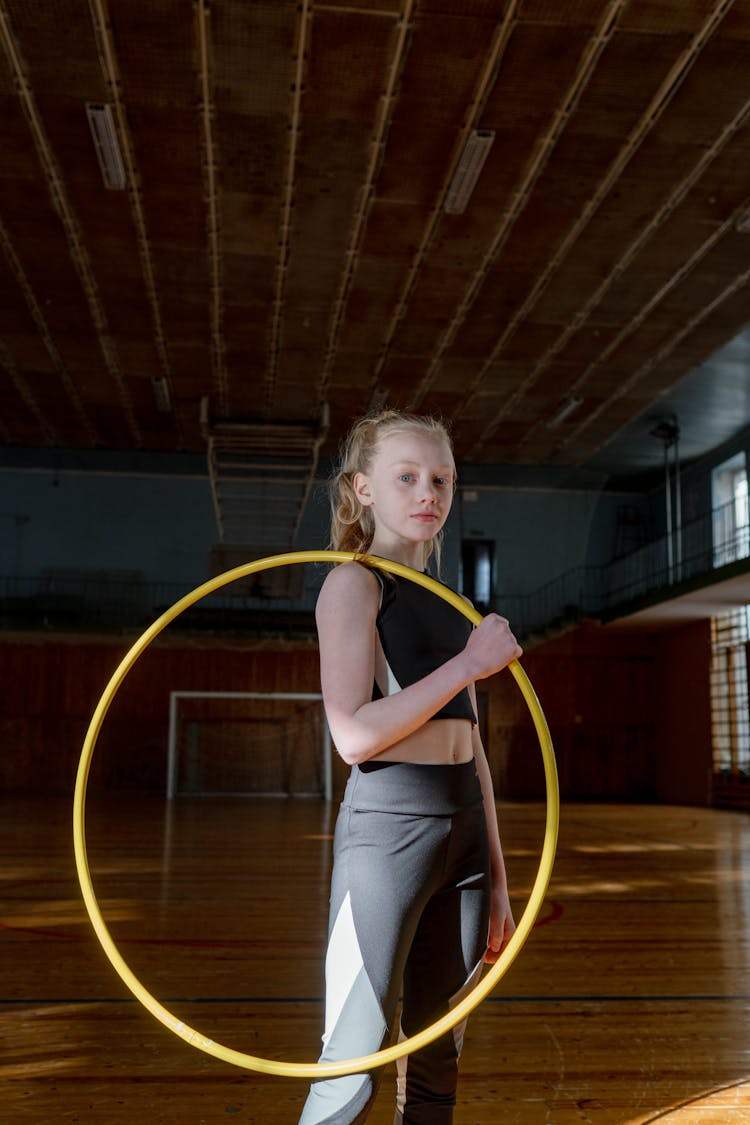 Girl With Hula Hoop On Shoulder Wearing A Black Sports Attire