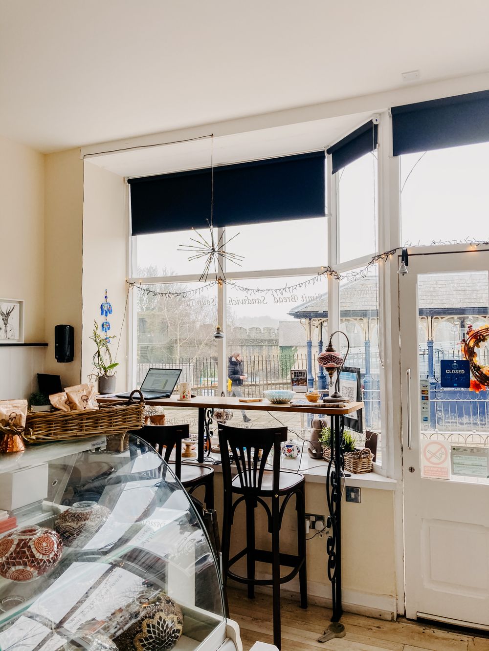 Light-filled café interior with a counter and high table — illustrative stock photograph