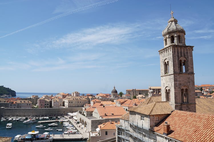 Church Tower In City With Sea Bay