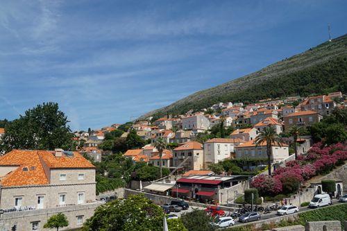 Free Charming hillside view of orange-roofed buildings in Dubrovnik, Croatia under a clear blue sky. Stock Photo