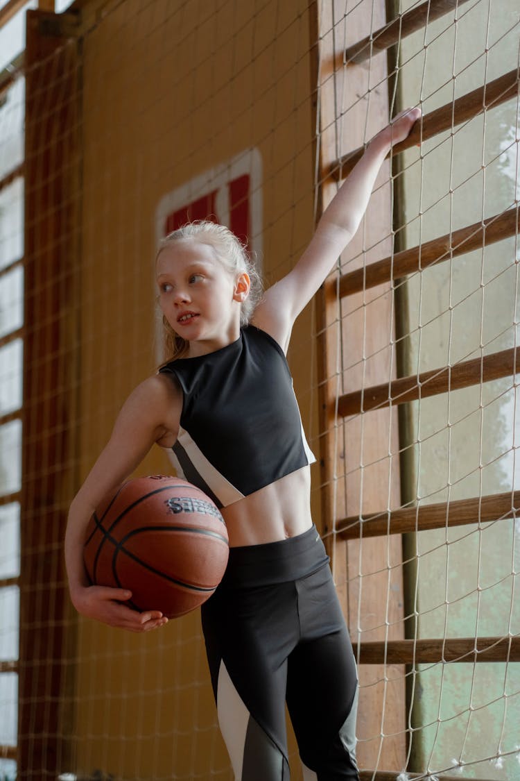 Girl In Black Clothes Holding A Basketball