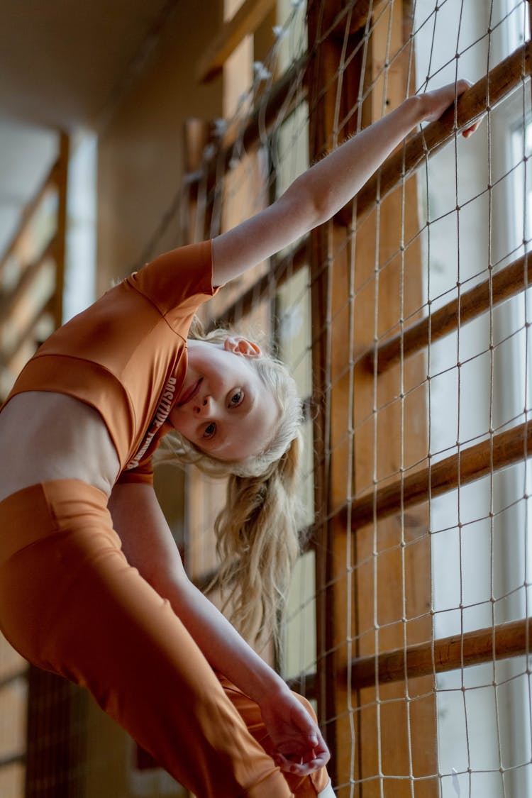 A Girl Climbing A Net