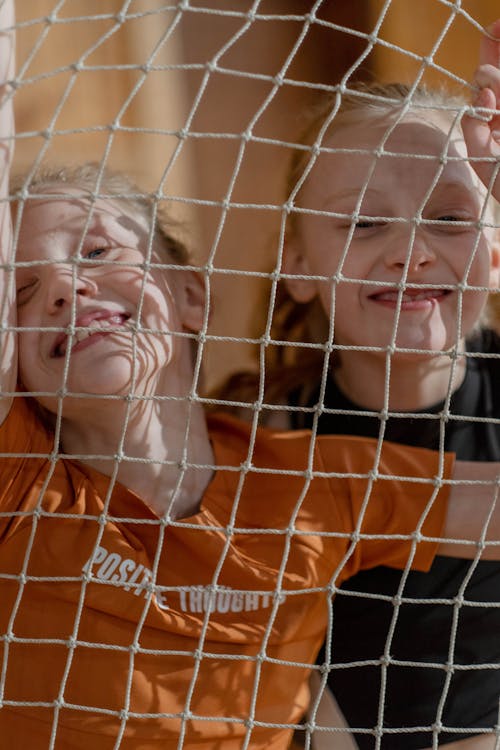 Free Girls Smiling Behind the Net Stock Photo