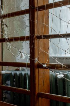 Detailed view of climbing net and wooden bars in an indoor play area, showcasing texture and design.