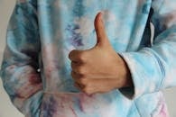 Persons Left Hand Doing Thumbs Up