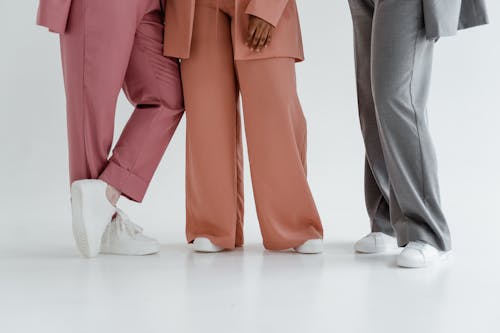 Free People Wearing Pants in Different Colors and White Shoes Stock Photo