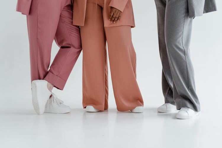 People Wearing Pants In Different Colors And White Shoes