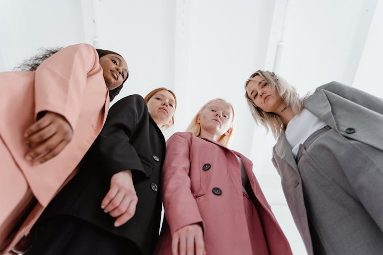 A Low Angle Shot Of Women Wearing Blazers In Different Colors