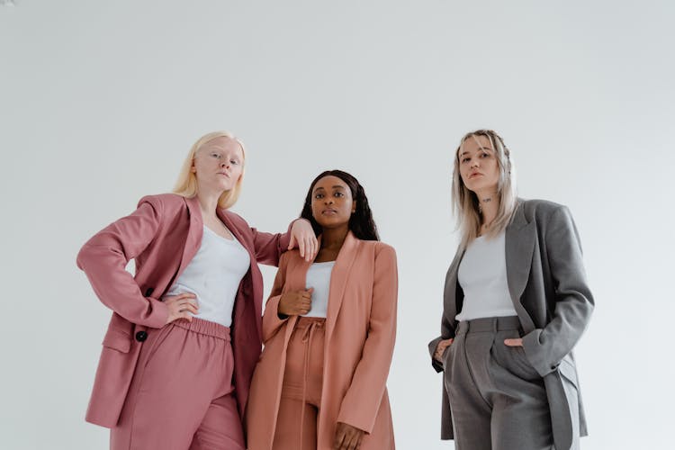 A Low Angle Shot Of Women Wearing Blazers In Different Colors