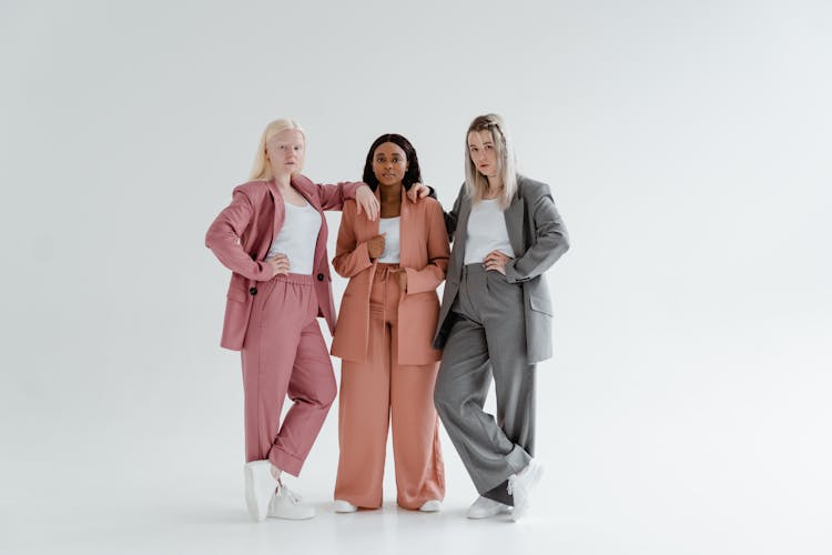 Women In Blazer And Pants Standing While Wearing White Shoes