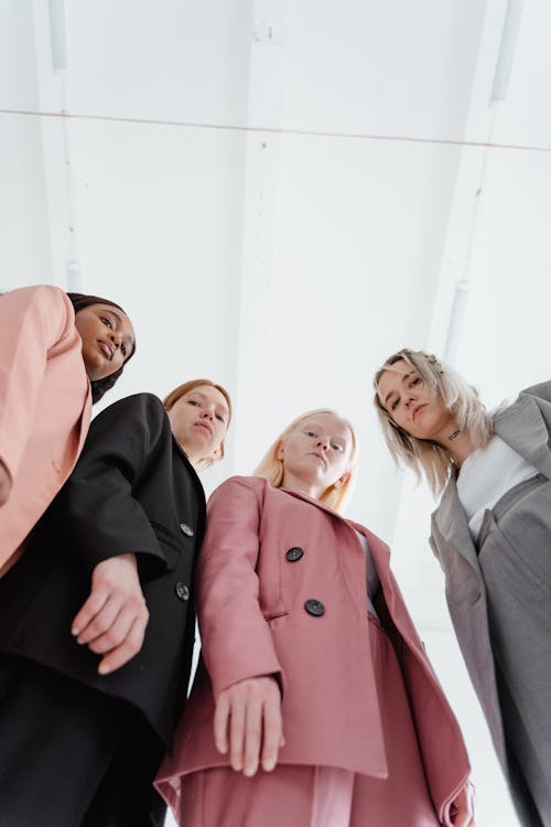 A Low Angle Shot of Women Wearing Blazers in Different Colors