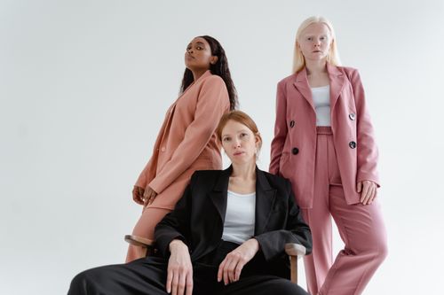 Free Three diverse women posing confidently in stylish blazers in a white studio setting. Stock Photo