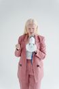 Woman in Pink Coat Holding White Ceramic Mug