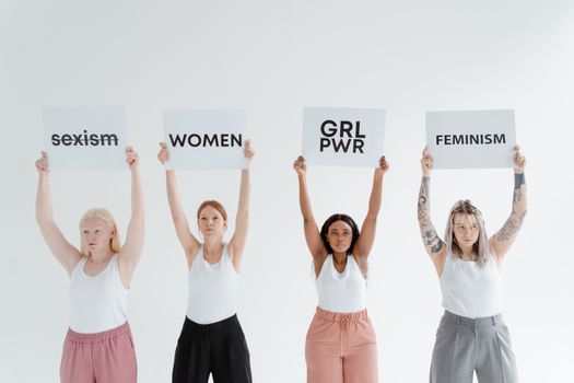 Women Holding Postcards With Printed Words 