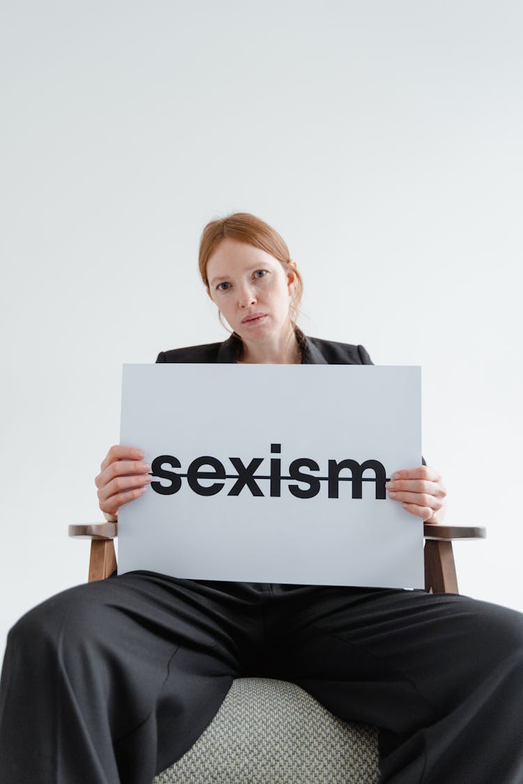 Woman Holding A Sexism Card