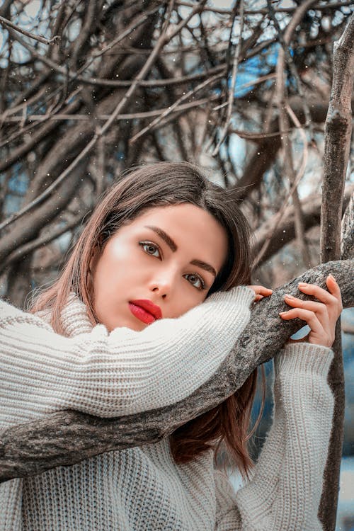 Free Close-Up Shot of a Pretty Woman in Gray Knitted-Sweater Looking at Camera Stock Photo