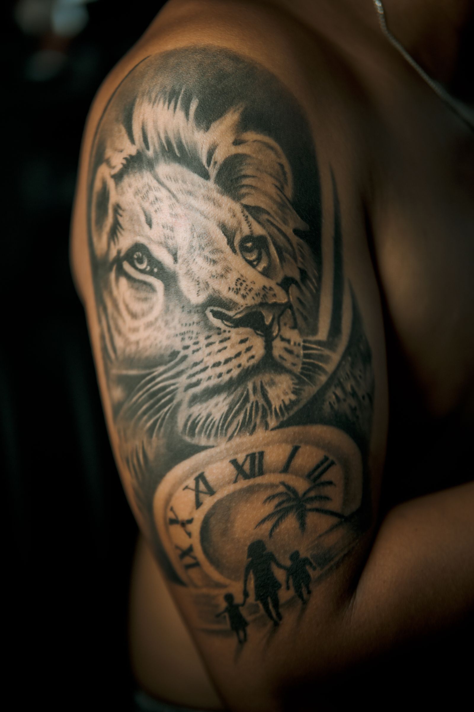 Lion tattoo artwork on a man's forearm