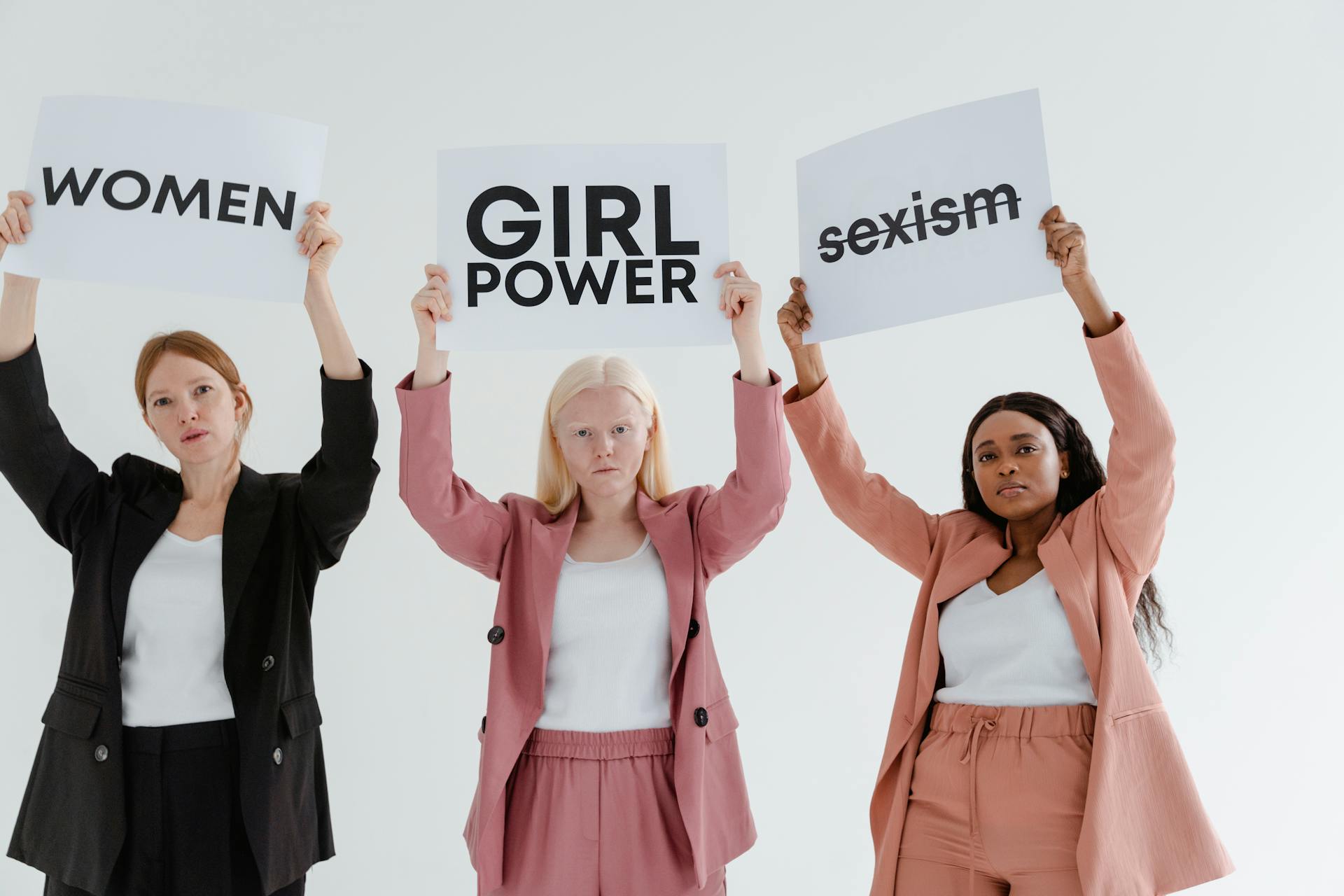 Photograph of Women Holding White Cards