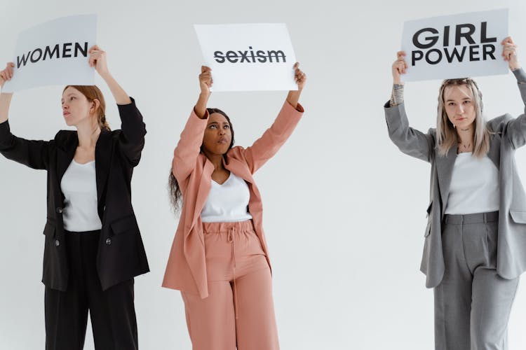 Women In Blazers Holding White Cards