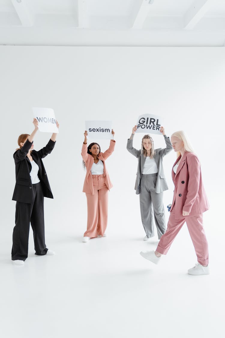 A Group Of Women Protesting While Holding Placards