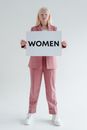 Woman in Pink Pants Holding White and Black I Love You Print Card