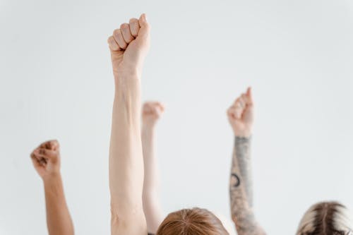 Free People Arms Raised with Clenched Fist Stock Photo