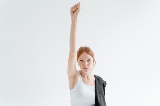 A Woman in White Tank Top Raising Her Right Hand