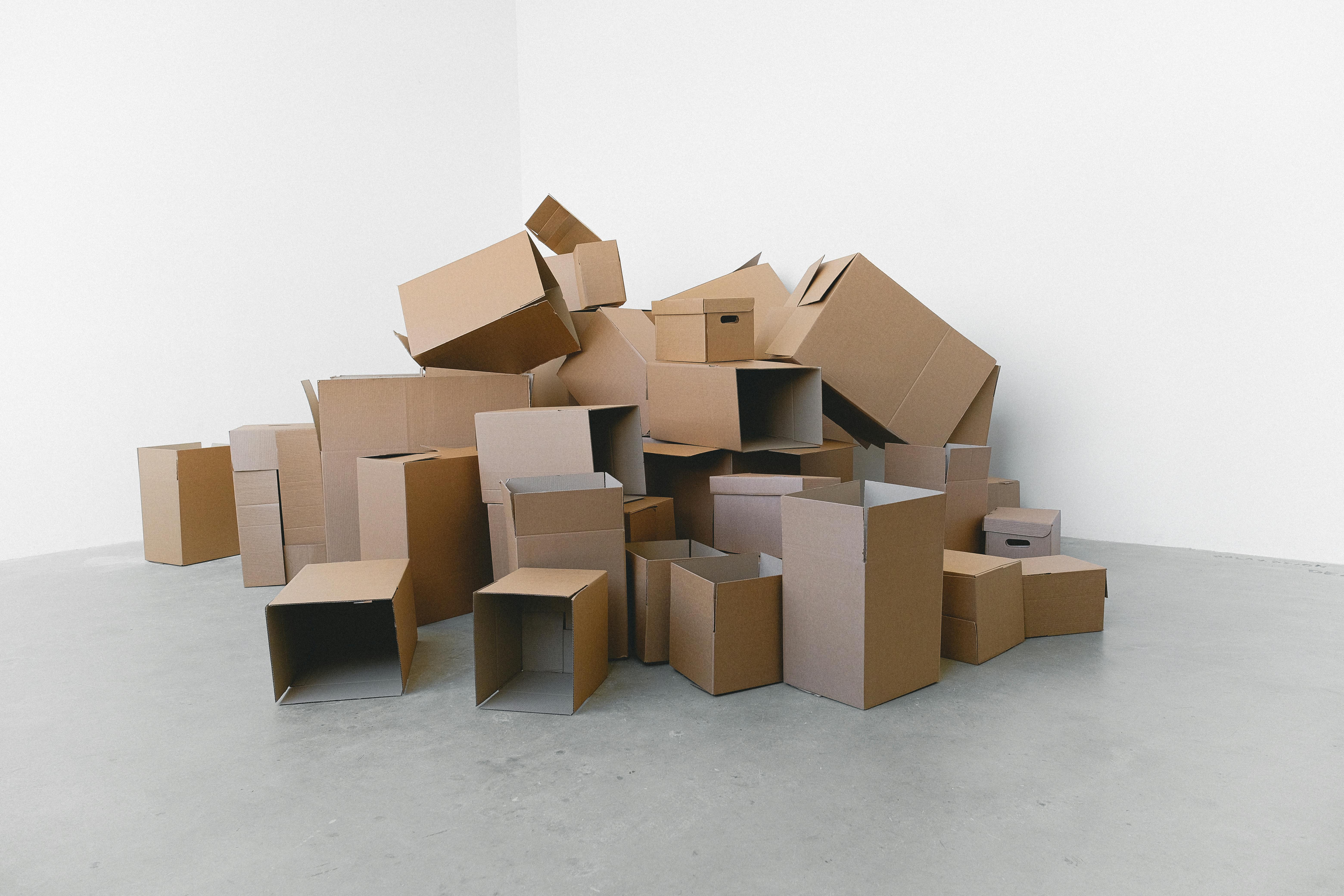 stack of carton boxes on floor in rented house