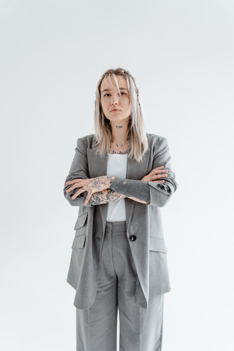 Woman In A Gray Blazer Posing With Her Arms Crossed