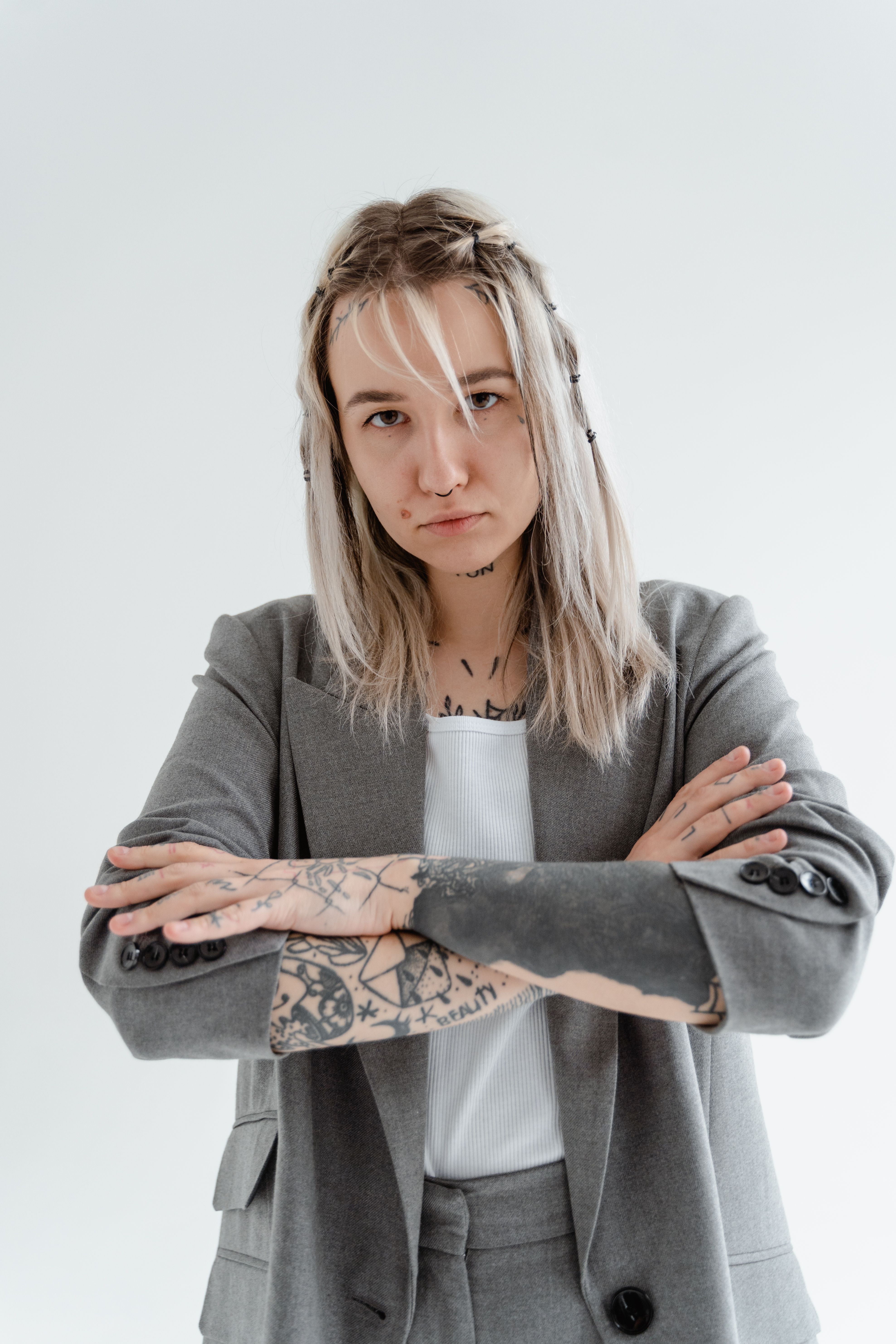 Woman in Gray Blazer with Arms Crossed · Free Stock Photo