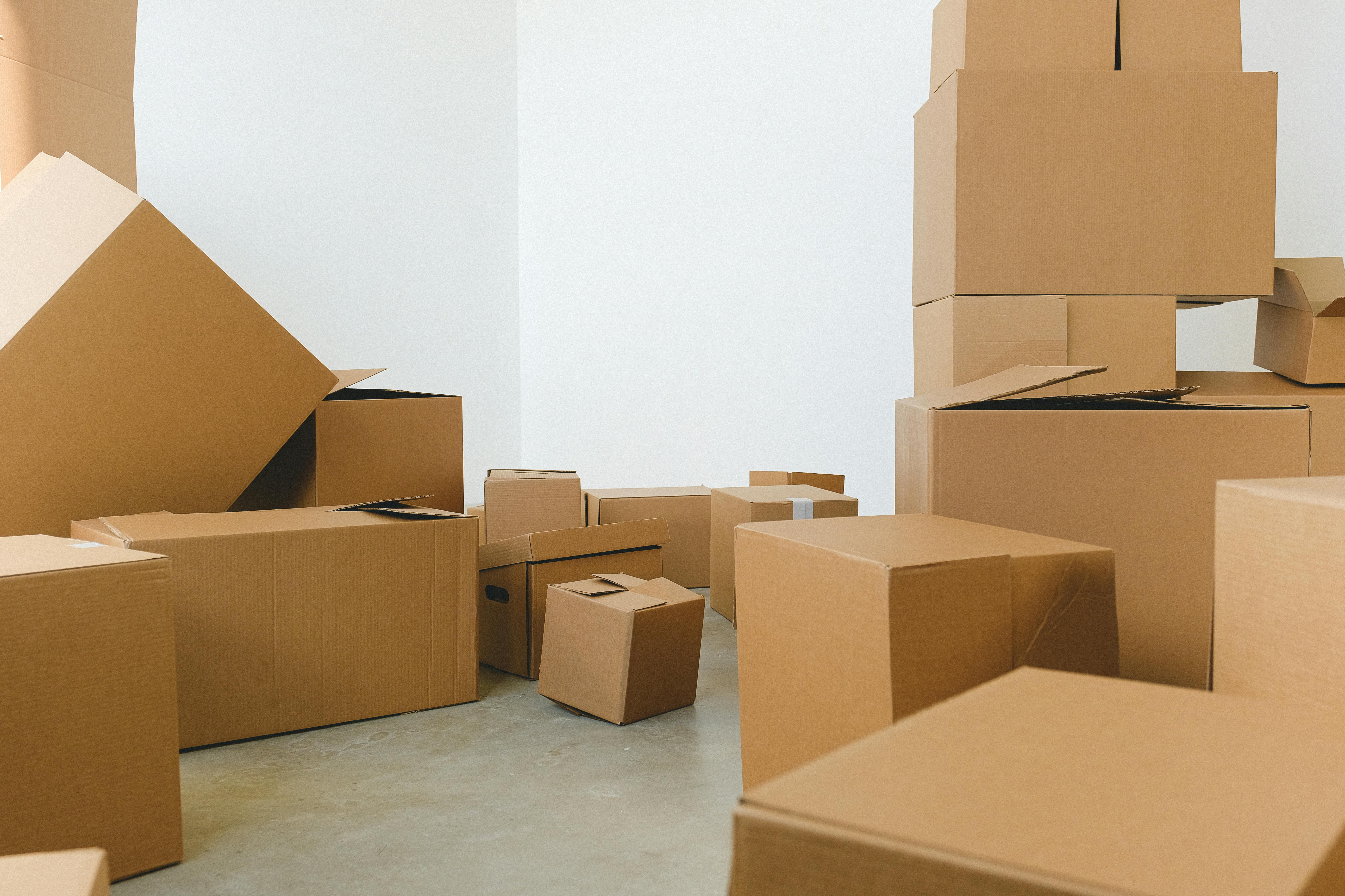 pile of cardboard boxes scattered on floor during relocation