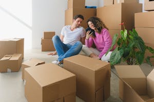 Woman Showing Her Phone to the Man while Sitting on the Floor