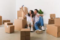 Man and Woman Sitting on Floor while Taking Selfie